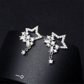 Elegant silver star earrings featuring a cluster of dazzling cubic zirconia diamonds.